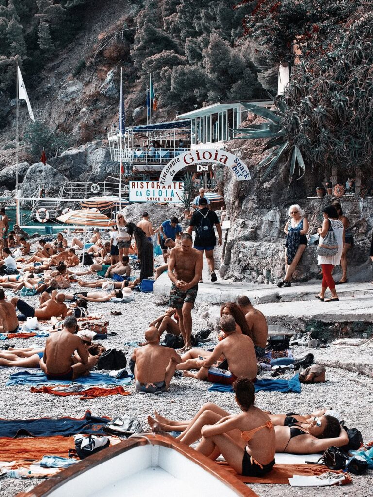 A photo of tourists relaxing in front of Gioia restaurant at Marina Piccola Beach in Capri, Italy