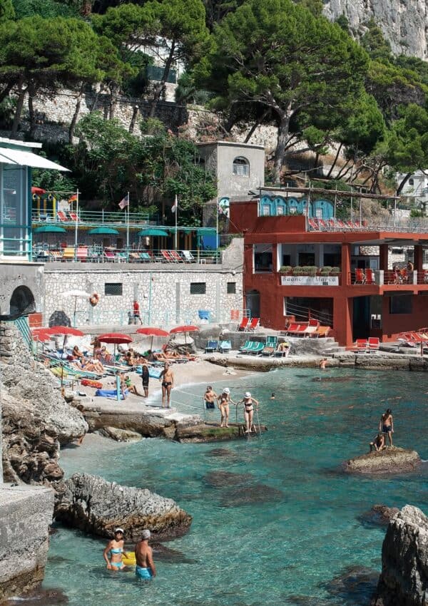 A photo of a restaurant near Marina Piccola beach in Capri Italy with sun beds and tourist relaxing at a Capri Beach Club.