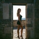 Victoria Van Der Berg in a stone doorway in the ancient city of Pompeii, Italy.