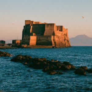 Castel dell Ovo at sunset with the silhouette of Vesuvius in the background Naples