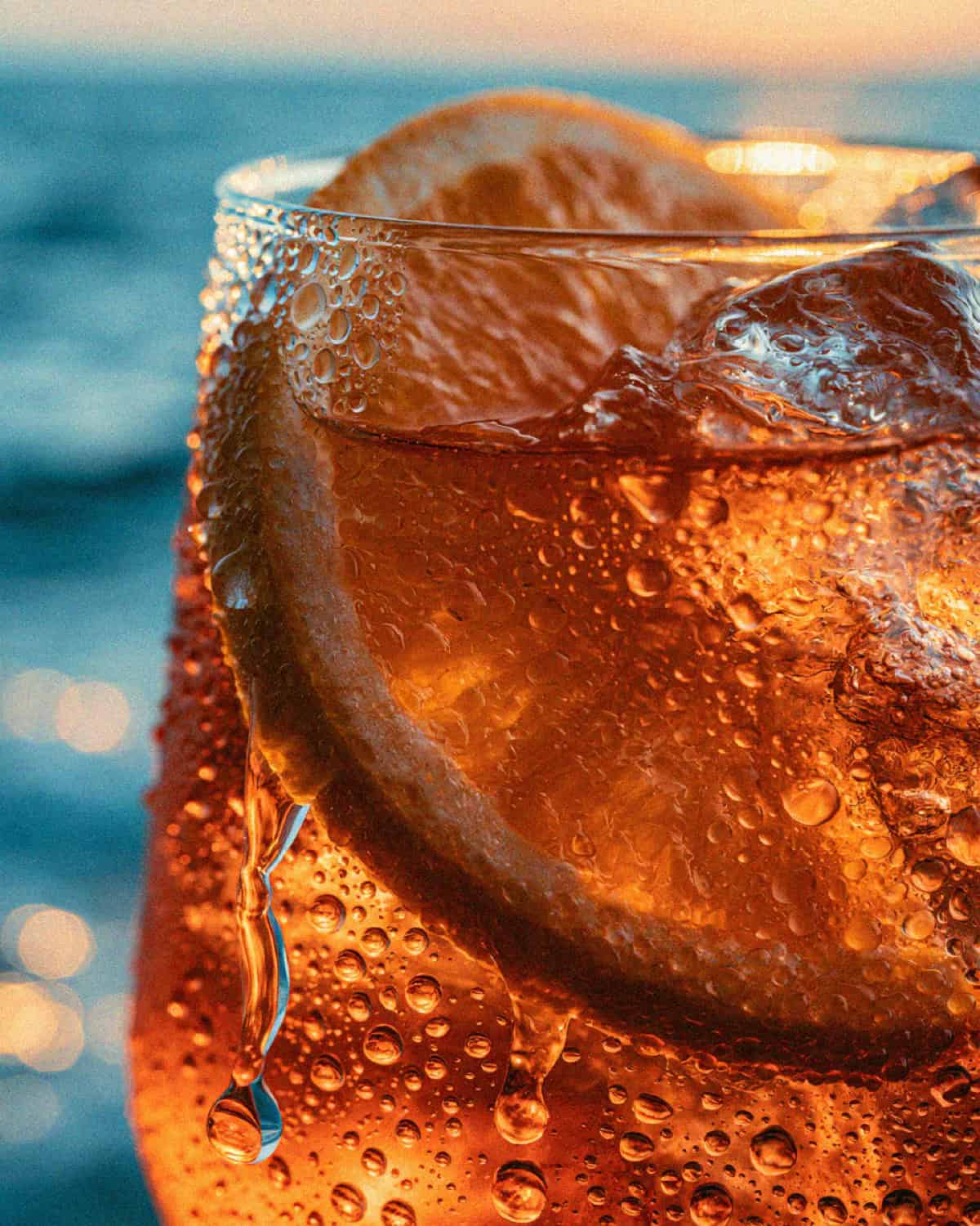 A cold orange spritz with ice on a table at a Cinque Terre beach club