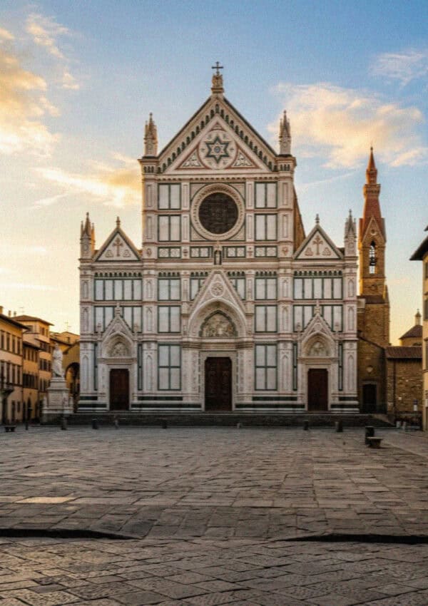 The marble facade of the Basilica di Santa Croce in Florence at golden hour