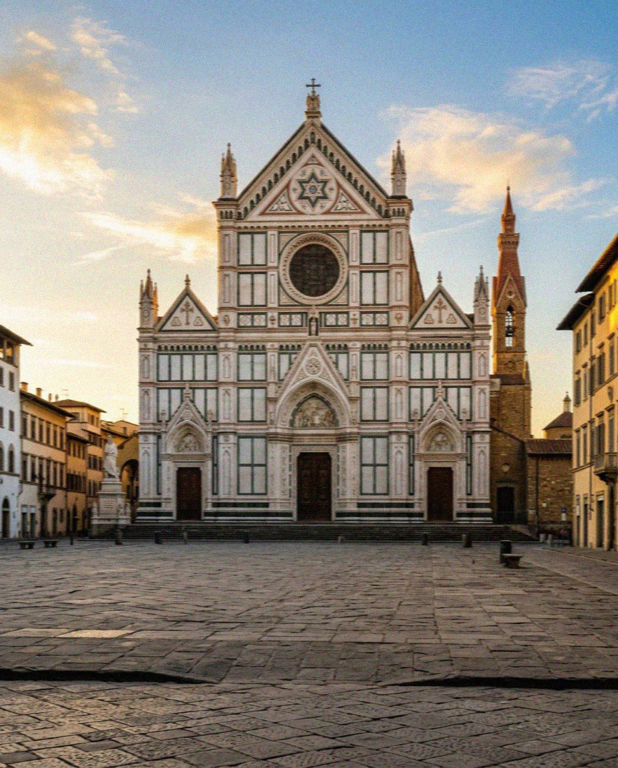 The marble facade of the Basilica di Santa Croce in Florence at golden hour