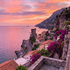 Sunset view of a medieval watchtower near Maiori on the Amalfi Coast, framed by cascading bougainvillea in pink and orange