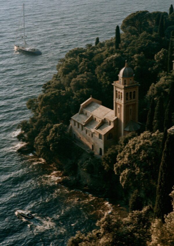 Aerial of the wooded Portofino headland and the castle above the bay