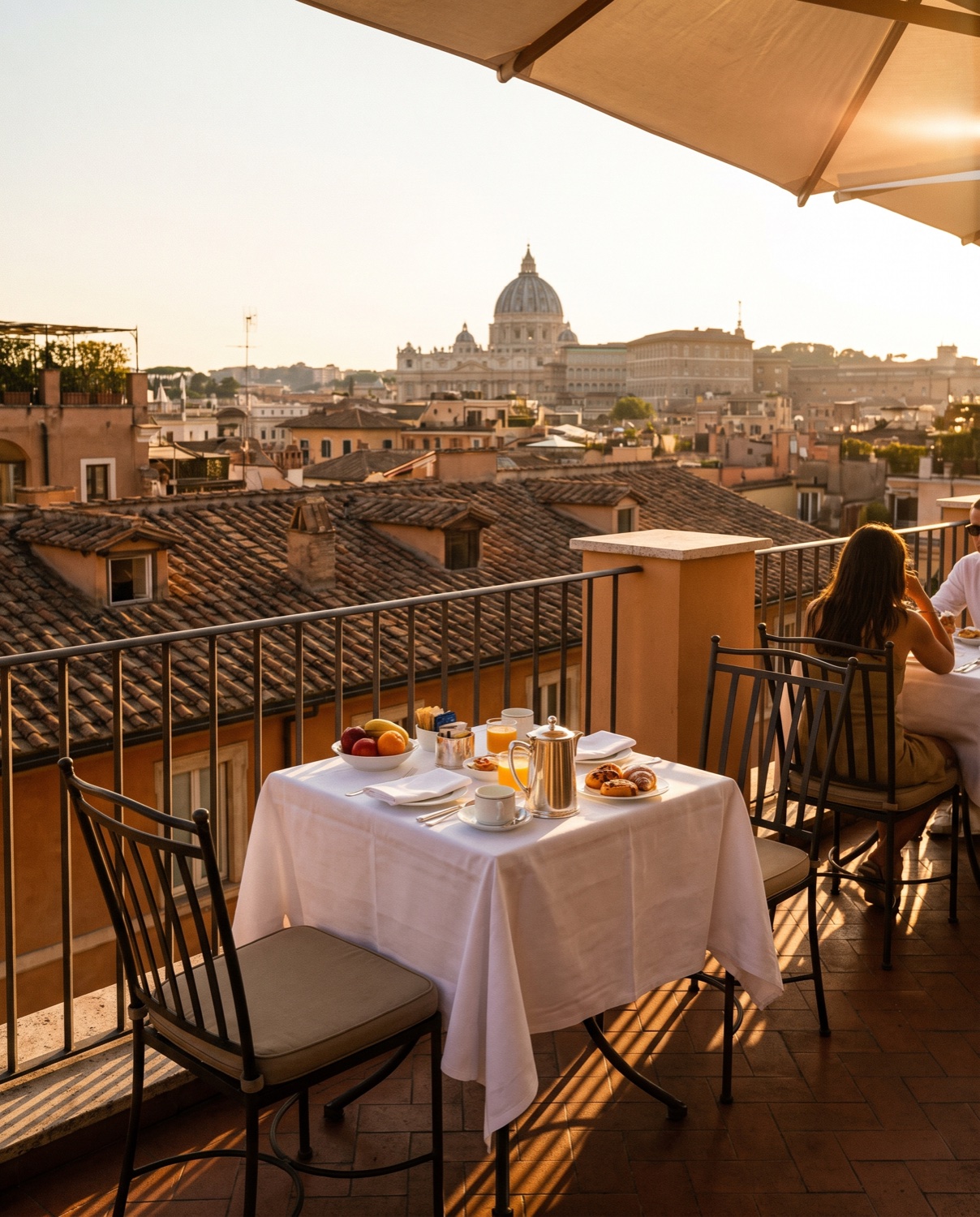 An elegant hotel terrace overlooking the rooftops of Rome at golden hour