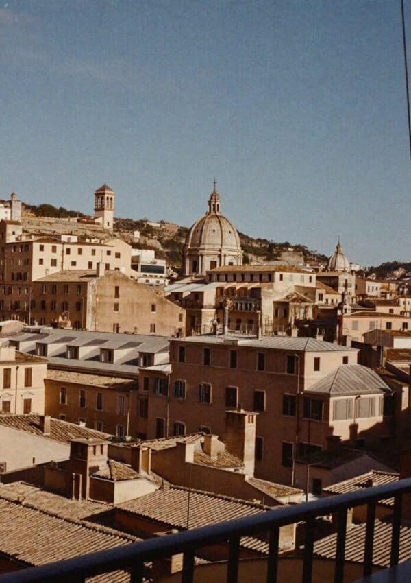 A view over the rooftops and domes of Rome from a terrace at golden hour