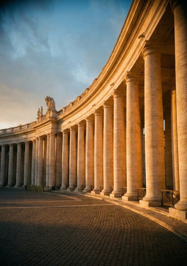 Bernini's curved colonnade of columns at St Peter's Square in Rome at golden hour