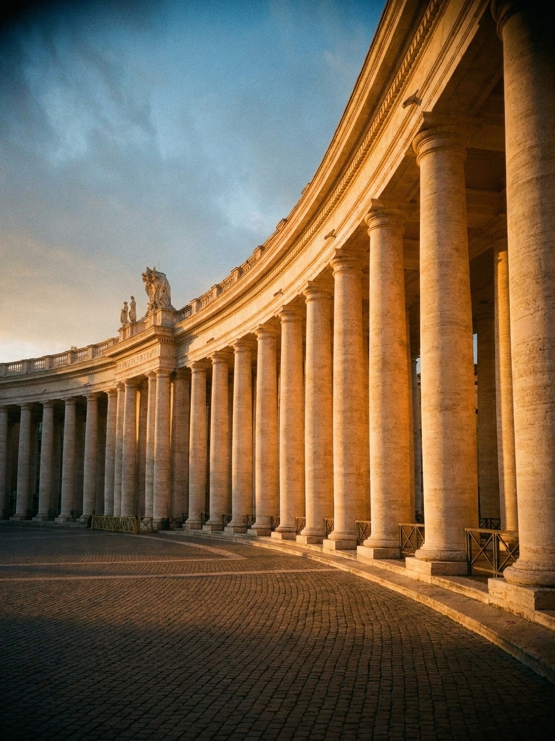 Bernini's curved colonnade of columns at St Peter's Square in Rome at golden hour