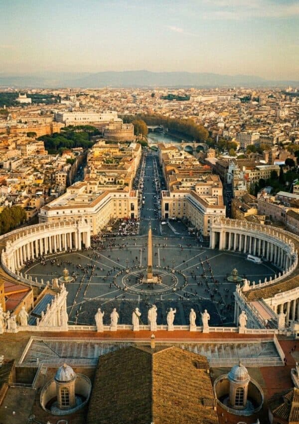 An aerial view of St Peter's Square in Vatican City with the curved colonnade and central obelisk