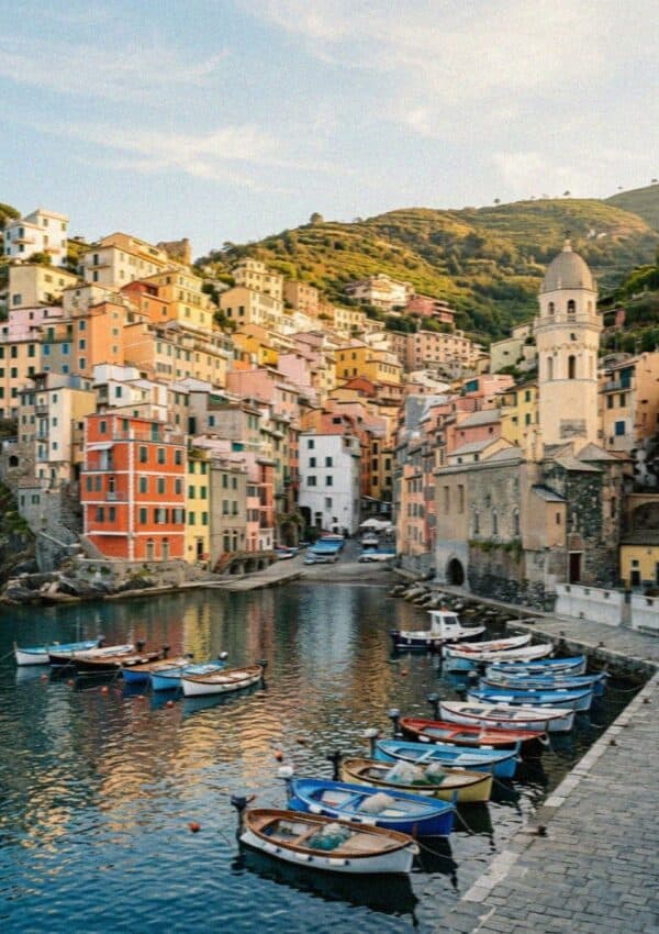 The harbour of Vernazza in Cinque Terre with fishing boats and the church