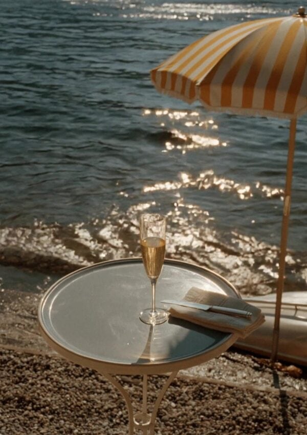 A glass of champagne beside Lake Como