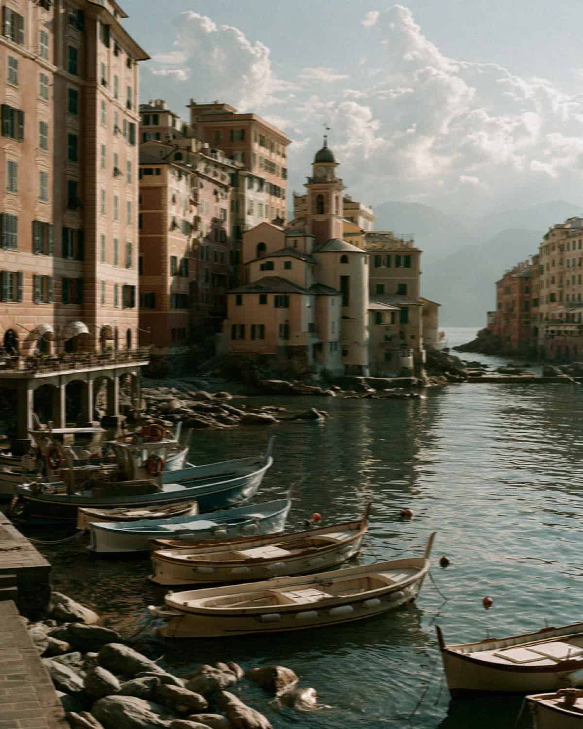 The tall pastel houses and fishing boats along the Camogli waterfront near Portofino