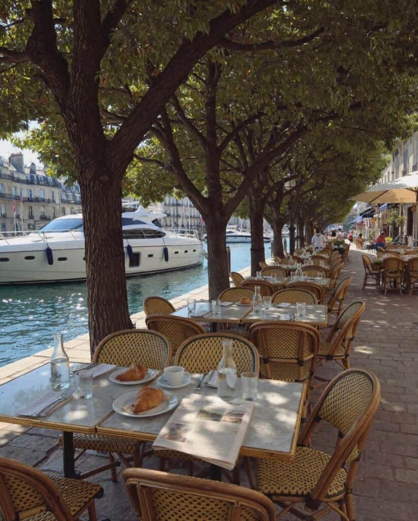 Victoria Van Der Berg at a dinner table on the French Riviera in the evening