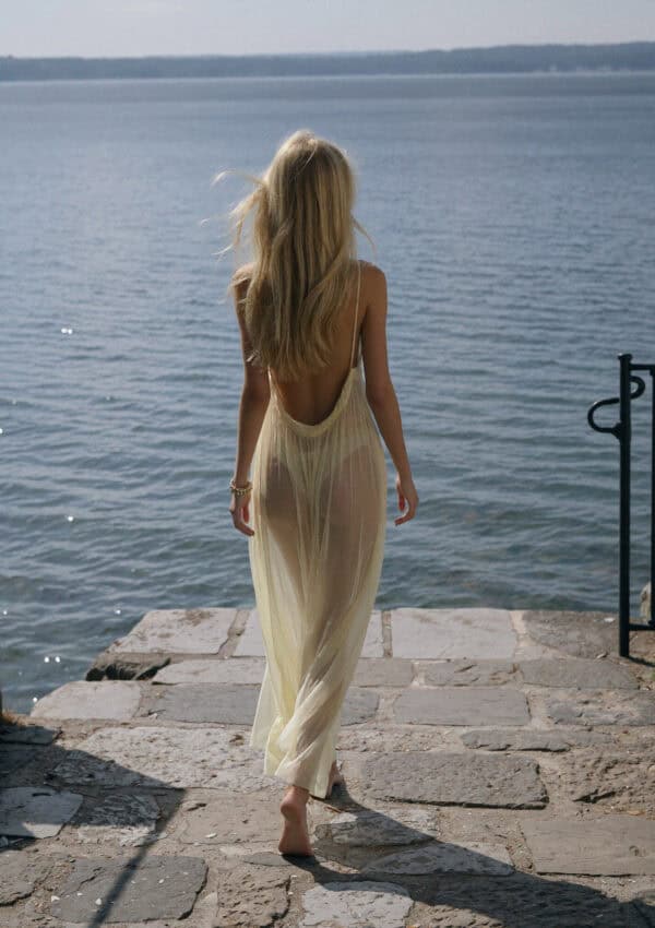 Victoria Van Der Berg walking down stone steps to the water on Lake Como