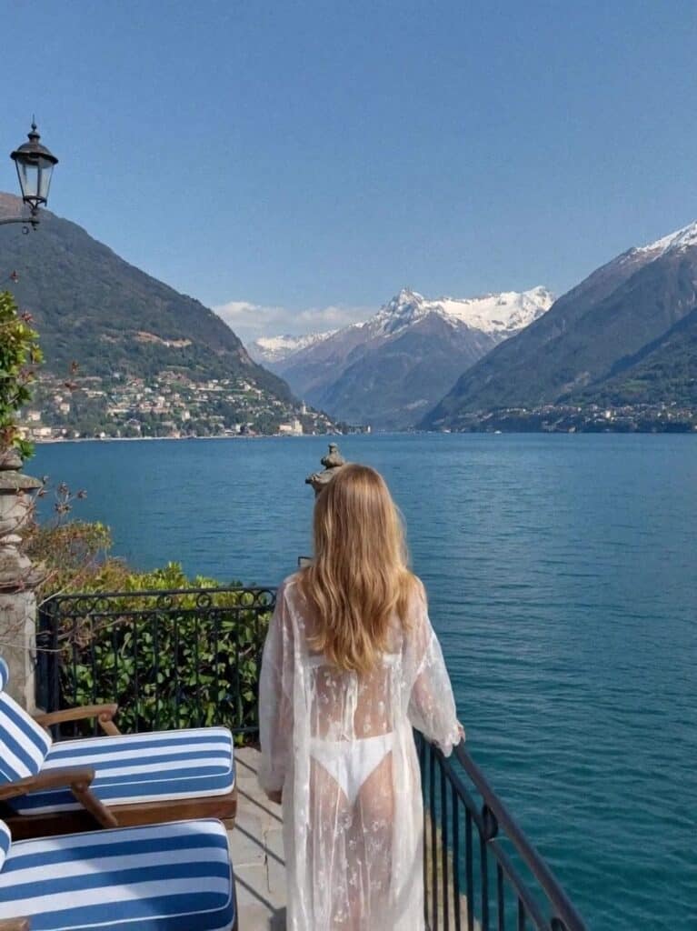 Victoria Van Der Berg on a lakeside terrace looking north to the mountains, Lake Como