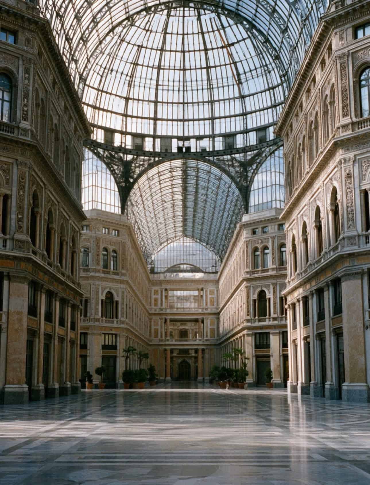 The vast iron and glass dome of Galleria Umberto I in Naples, almost empty in the morning light