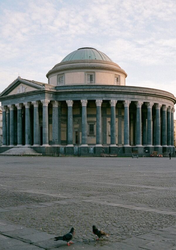 The domed neoclassical basilica of San Francesco di Paola in Naples at first light with pigeons on the empty piazza