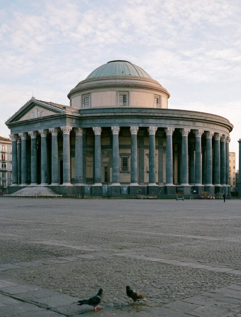 The domed neoclassical basilica of San Francesco di Paola in Naples at first light with pigeons on the empty piazza