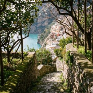 Victoria Van Der Berg in a white dress standing on a cliffside above the Amalfi Coast near Positano