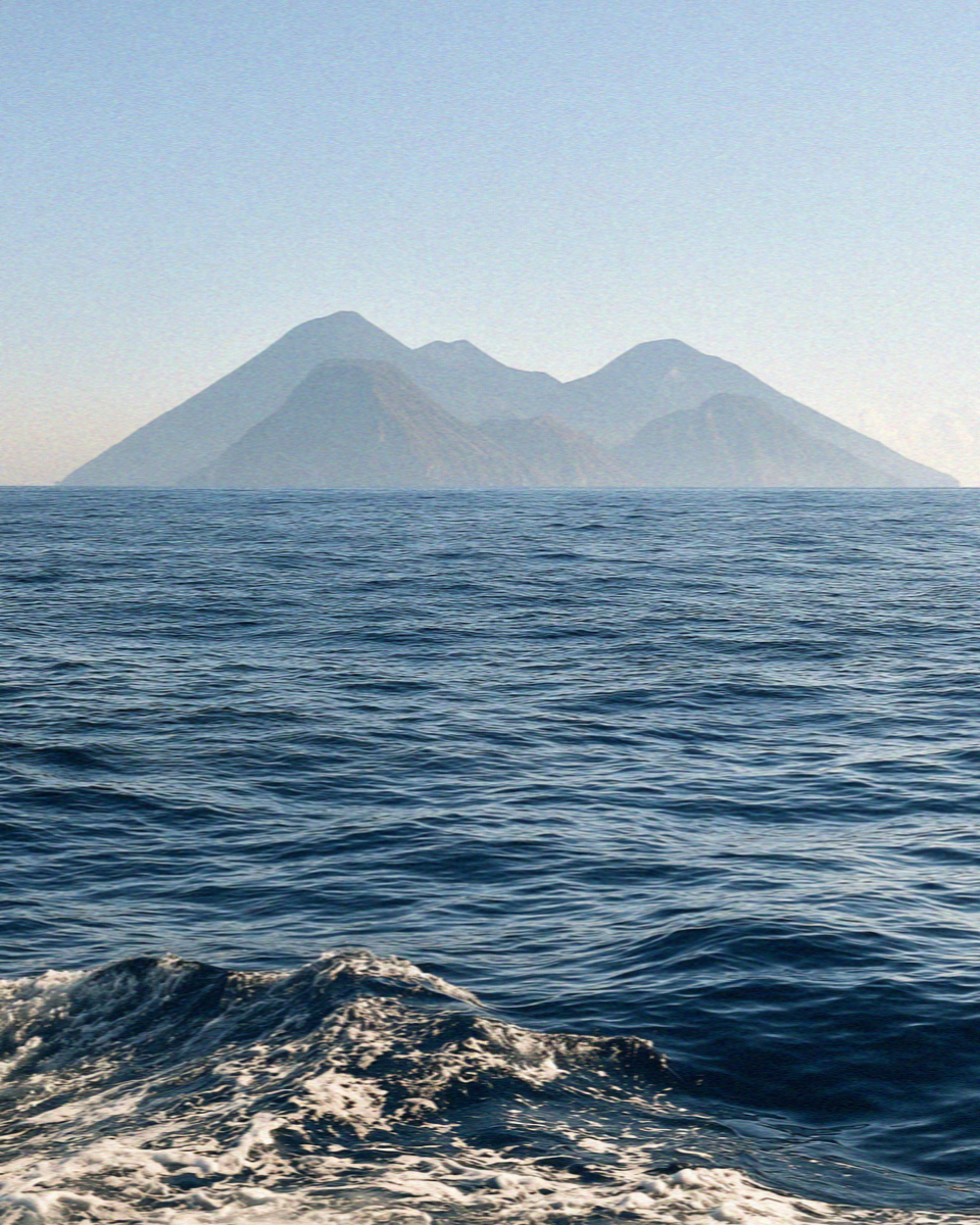 The volcanic cones of the Aeolian Islands seen from the sea in Sicily