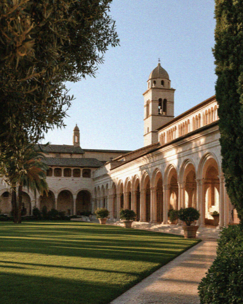The arcaded Piazza Inferiore before the Lower Church of San Francesco in Assisi