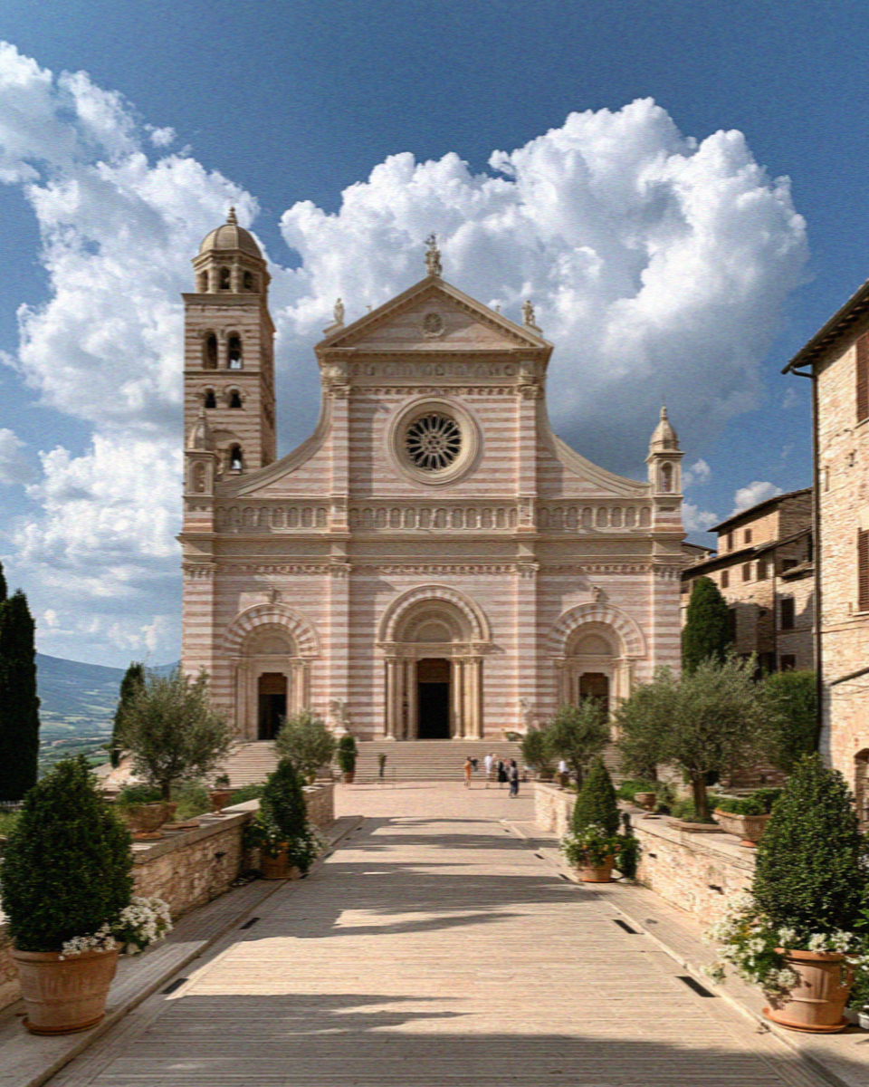 The Basilica of Santa Chiara in Assisi, its pink and white striped facade and rose window