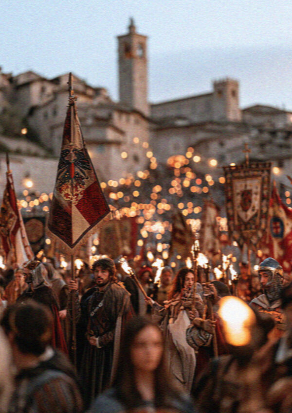 The Calendimaggio spring festival in Assisi with costumed townspeople and banners