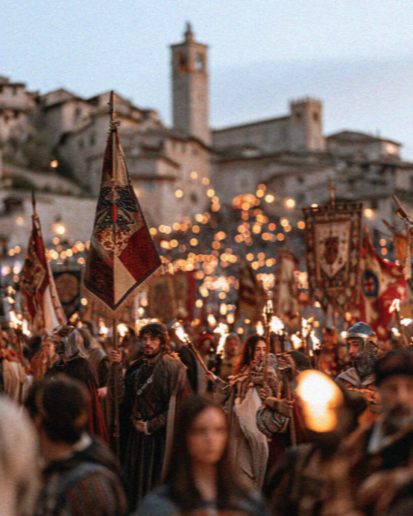 The Calendimaggio spring festival in Assisi with costumed townspeople and banners