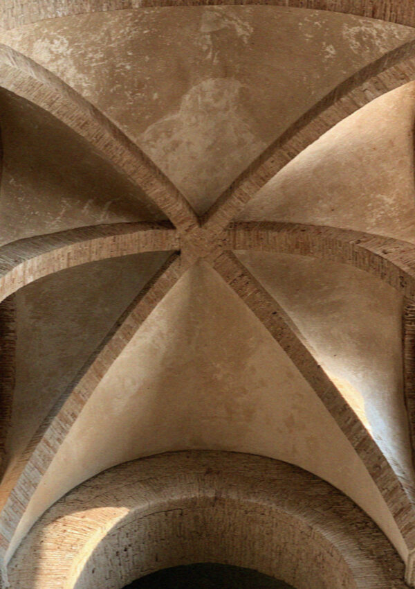 Looking up at a ribbed medieval stone vault above the western entrance of the basilica in Assisi