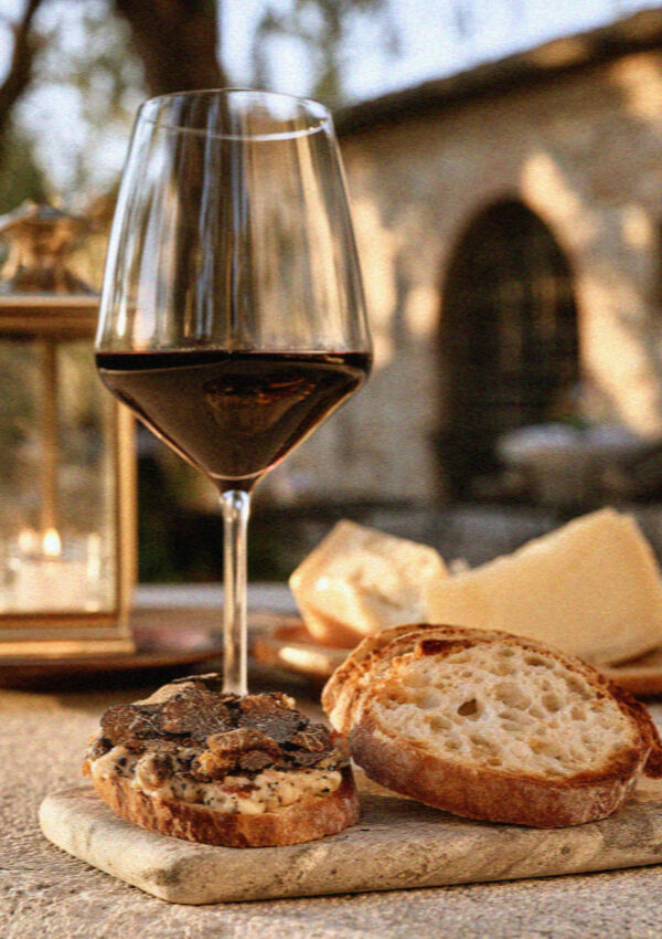 A glass of Sagrantino di Montefalco wine with truffle crostini and cheese