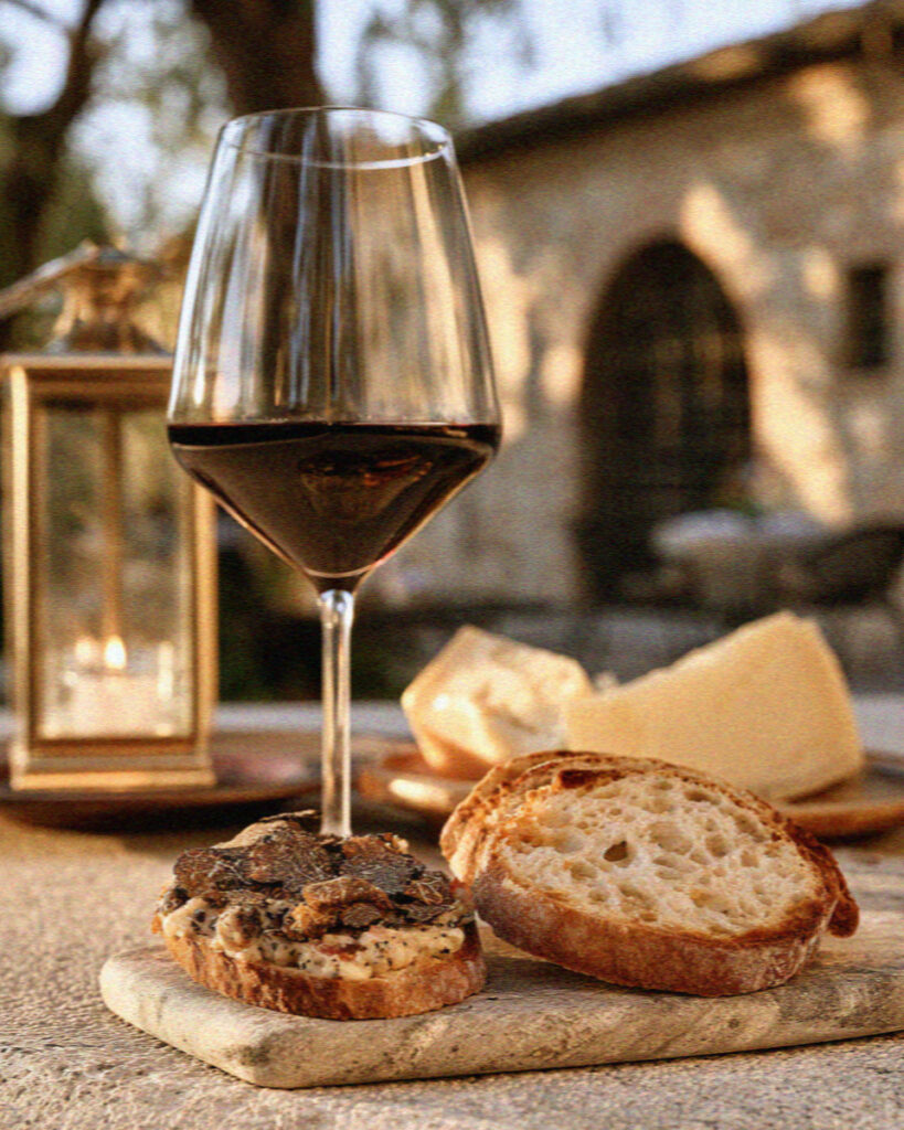 A glass of Sagrantino di Montefalco wine with truffle crostini and cheese
