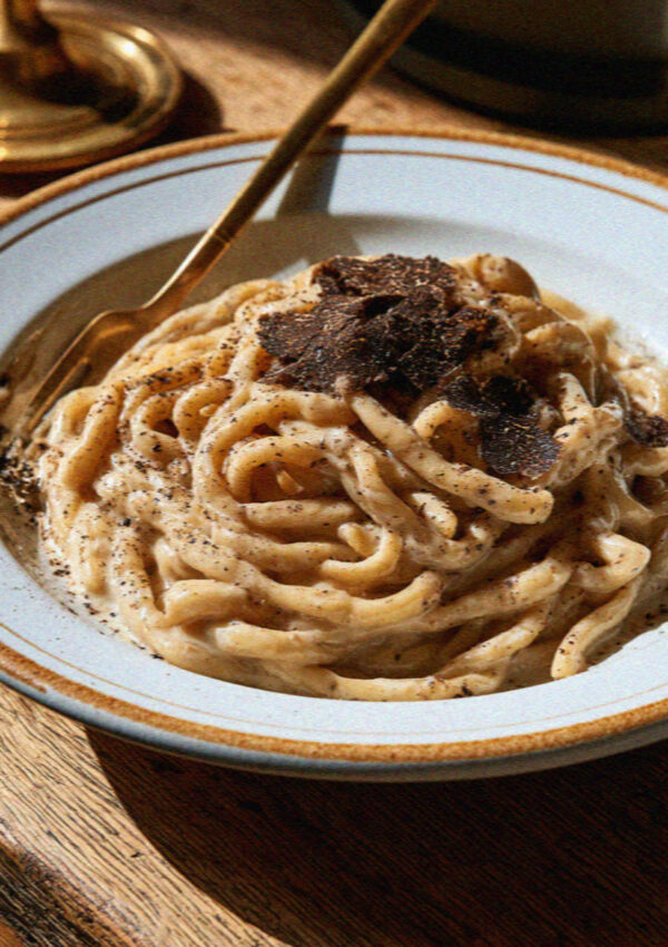 Umbrian strangozzi pasta with shaved black truffle on a rustic ceramic plate