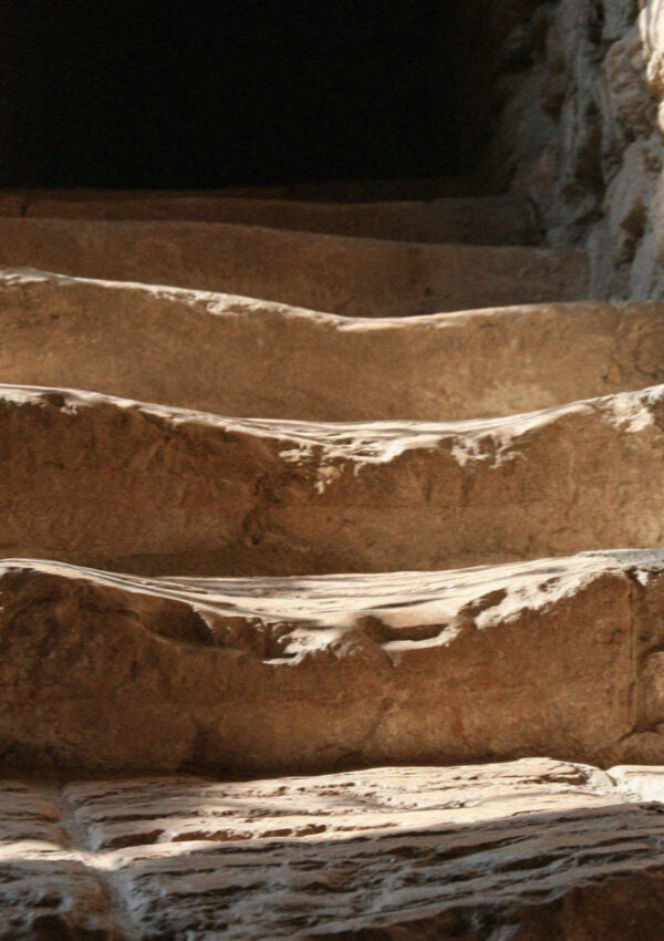 Medieval stone steps in Assisi worn into deep smooth hollows by centuries of feet