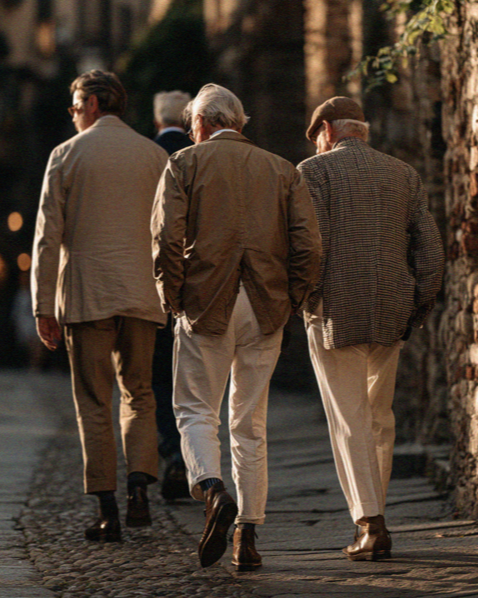 Old men in jackets walking a lane in Bergamo
