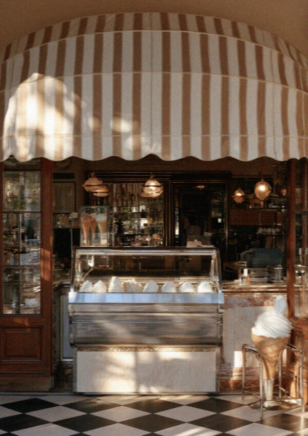 A pasticceria shopfront with a striped awning in Bergamo