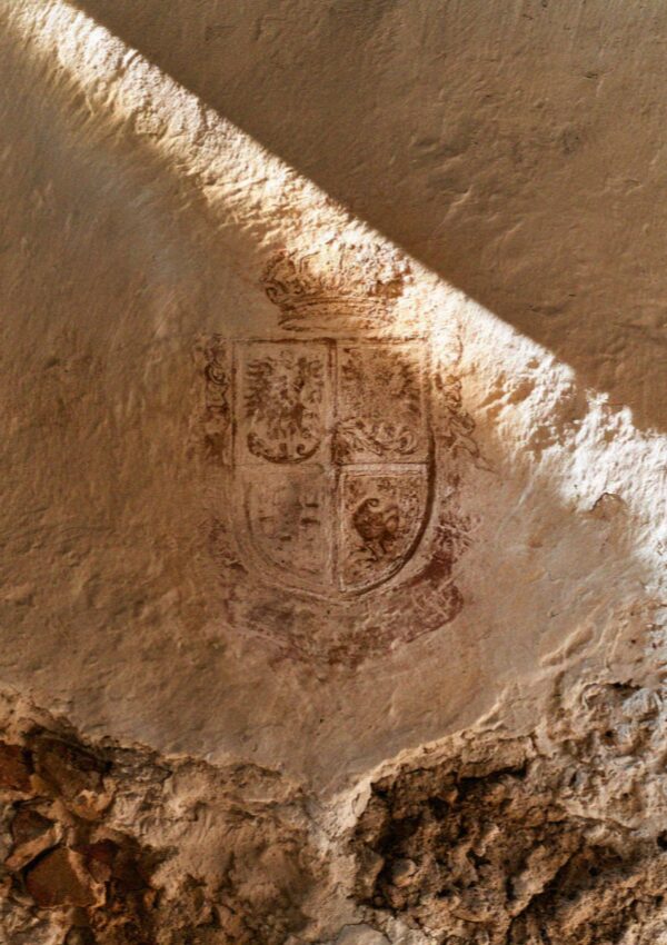 A painted heraldic crest on a vaulted wall of the old university in Bologna