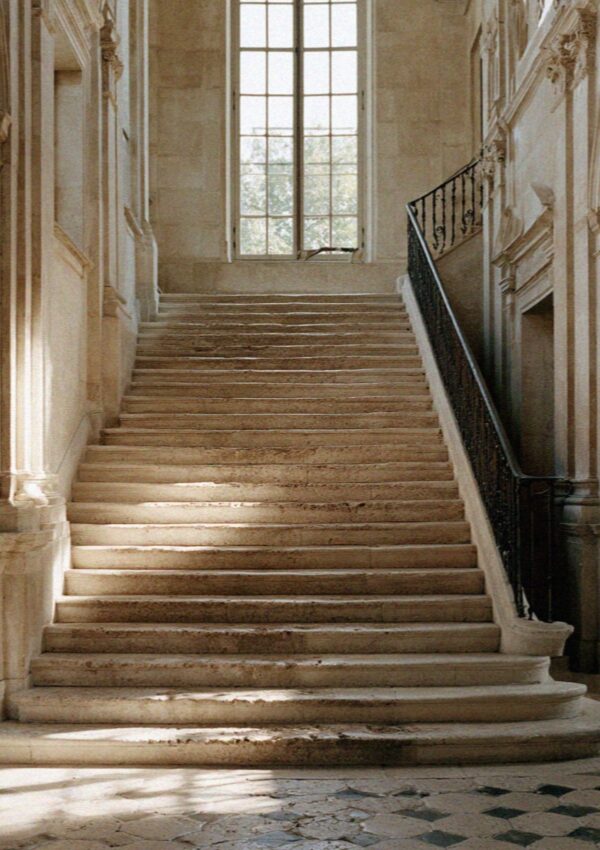 A wide worn stone staircase in an old Bologna palazzo