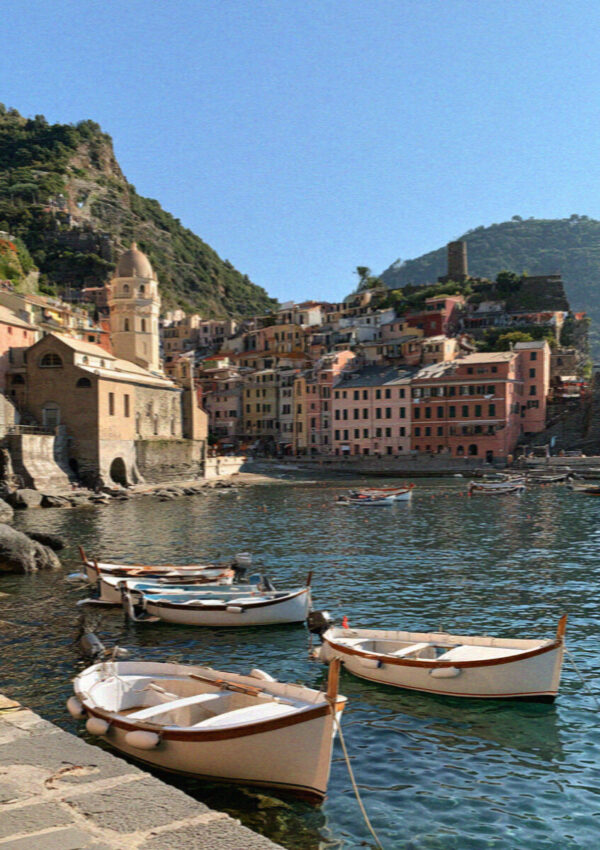 The harbour of Vernazza in the Cinque Terre with pastel houses above a small port