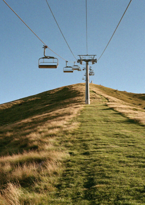 A chairlift climbing a grassy ridge in the Dolomites