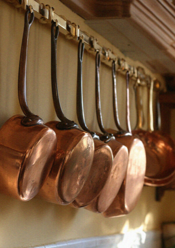 Copper pots and pans hanging in a maso kitchen in the Dolomites