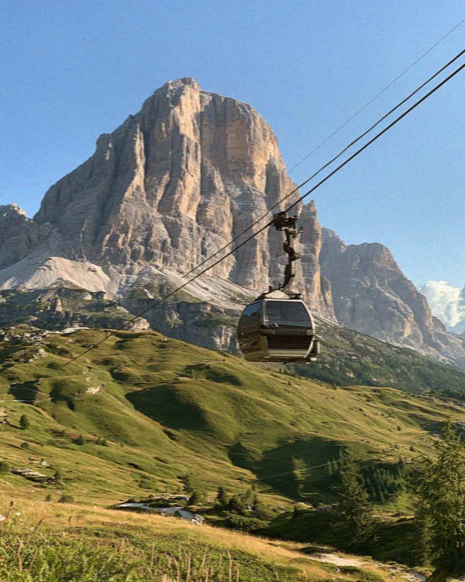 A cable car climbing toward the Tofana above Cortina d'Ampezzo, Dolomites