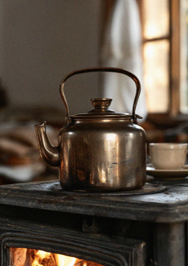 An enamel coffee pot on a wood stove in a maso in the Dolomites