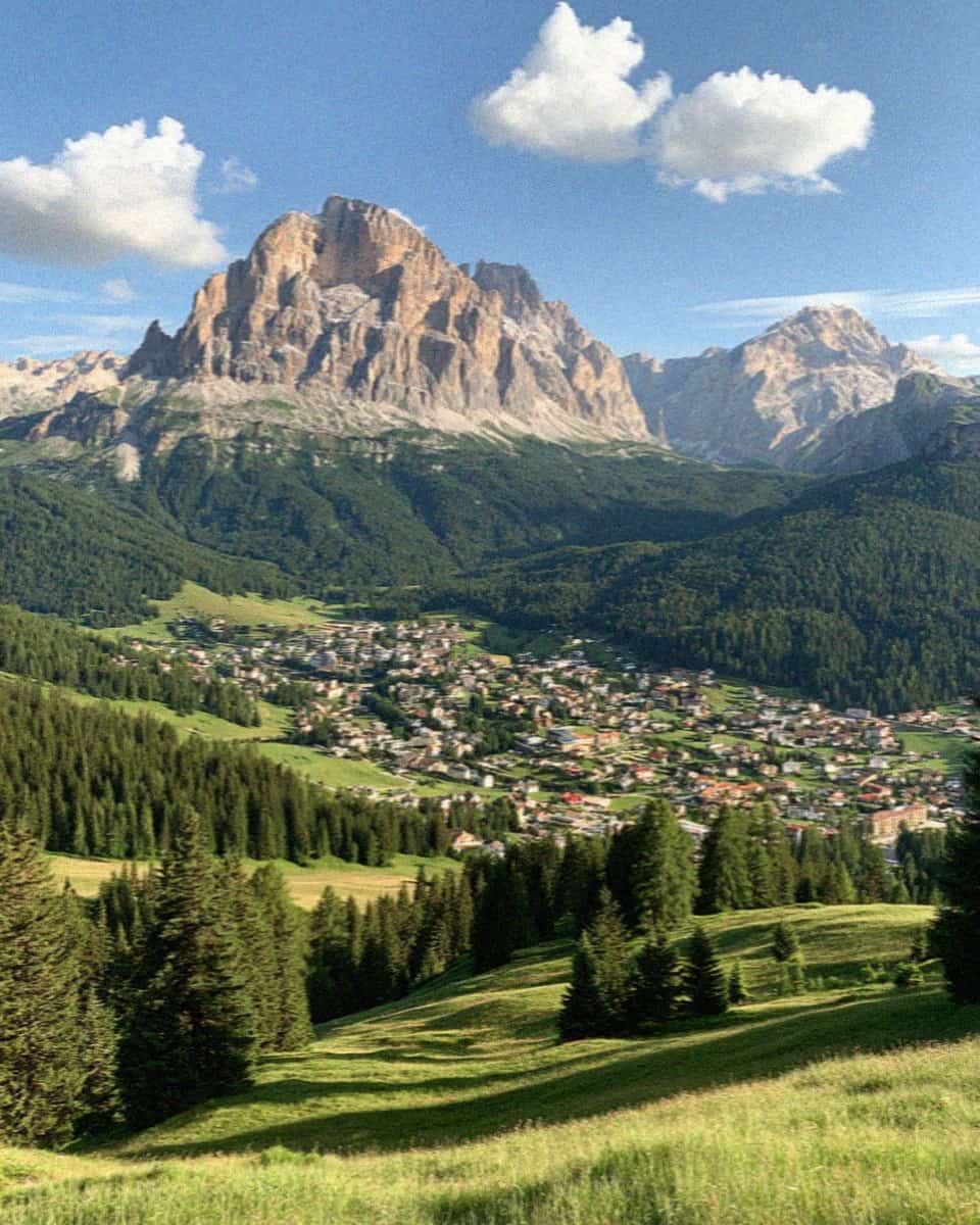 The village of Selva di Val Gardena in its green valley beneath the Sella massif, Dolomites