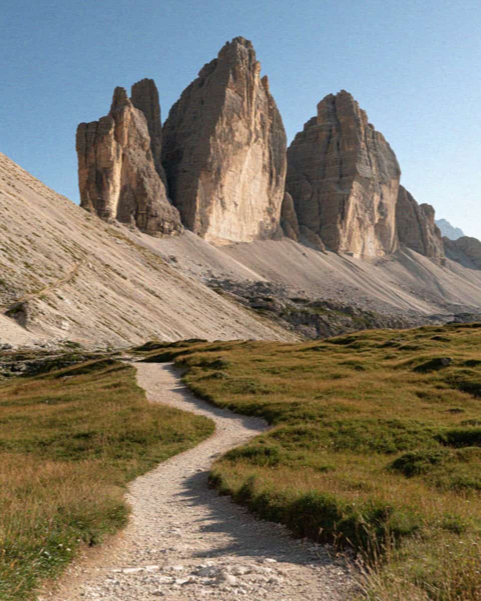 The trail looping around the base of the Tre Cime di Lavaredo through alpine meadow, Dolomites