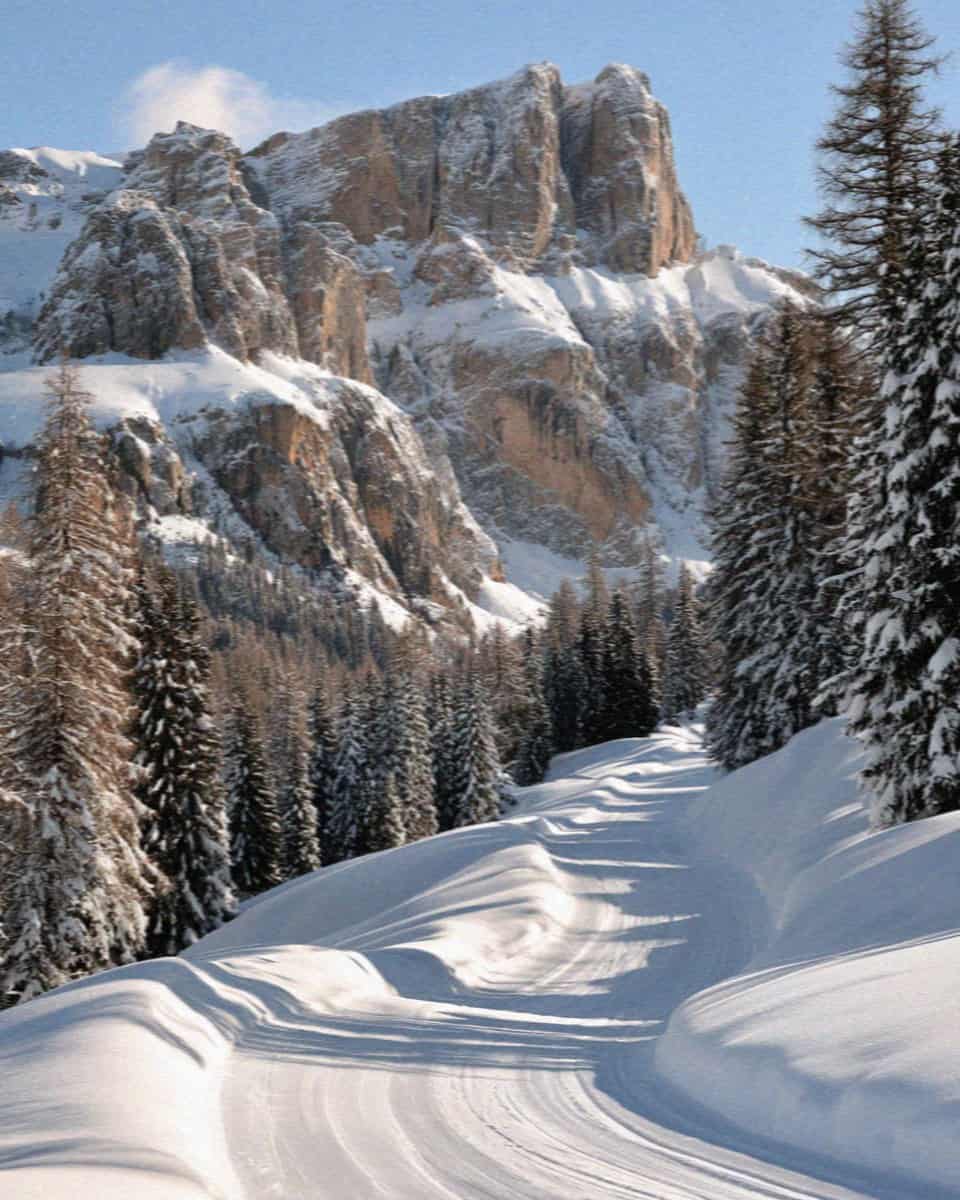 Snow-covered ski pistes below the Sella massif in the Dolomites