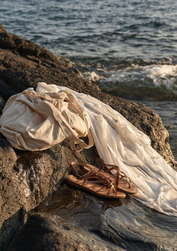 A shirt and sandals left on the rock beside the sea at Sorgeto on Ischia