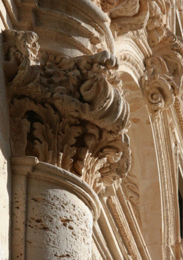 Deeply undercut baroque carving in soft limestone on a facade in Lecce