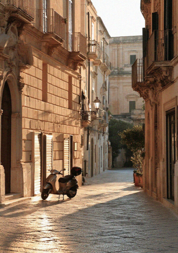 An empty street of golden limestone in Lecce at first light, shutters closed
