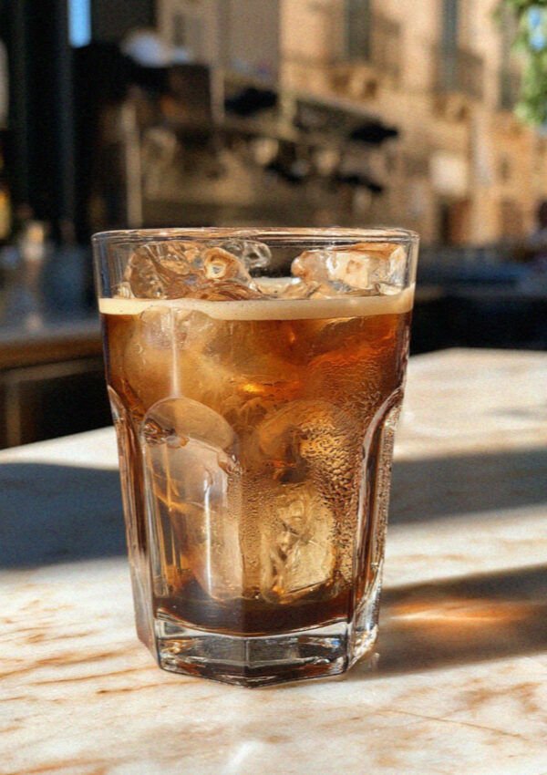 Caffe leccese, espresso over ice with almond syrup, on a marble bar counter in Lecce